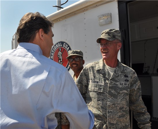 Texas Governor Rick Perry visits with Senior Master Sgt. Jonathan Karlin of Joint Force Headquarters J6, Friday, June 1, 2012 during the Texas Department of Emergency Management State Response Activation Exercise at the South Terminal of Austin Bergstrom International Airport. The Texas Military Forces was just one of the many state agencies and partners showcasing their capabilities to the Governor and other statewide leaders in preparation of the 2012 Hurricane Season.