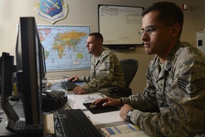 Photo of two soldiers working at computers