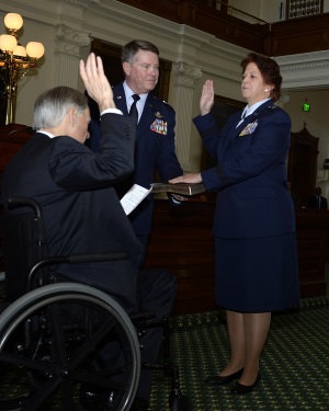 Texas Gov. Greg Abbott administers the oath of office to Brig. Gen. Dawn M. Ferrell during her promotion ceremony Jan. 15, 2016, in the Texas Capitol's Senate Chambers. Abbott appointed Ferrell as the Deputy Adjutant General - Air for the Texas Military Department's Texas Air National Guard. Ferrell is the first female to hold the rank of general officer in the TXANG. (Air National Guard photo by 1st Lt. Alicia Lacy/Released)
