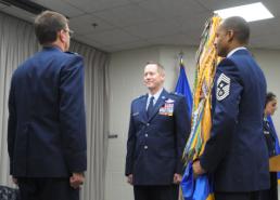 2nd Lt. Phil Fountain Brig. Gen. David M. McMinn (center), chief of staff of the Texas Air National Guard, prepares to receive the organization’s flag in a ceremony recognizing the change of command from Maj. Gen. Kenneth W. Wisian (left) to McMinn during a ceremony at Camp Mabry, in Austin, Texas, Jan. 23, 2016. Command Chief Master Sgt. Marlon Nation, the command chief master sergeant of the Texas Air National Guard, holds the flag prior to the change of command ceremony. (U.S. Air National Guard photo by 2nd Lt. Phil Fountain / Released)