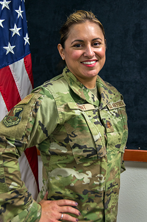 Texas Air National Guard Major Adrienne Saint, 136th Airlift Wing Logistics Readiness Squadron Officer, smiles in celebration of being cancer-free September 27, 2020, at Naval Air Station Joint Reserve Base Fort Worth, Texas. Saint recently celebrated her fourth anniversary of being breast cancer-free after a full bilateral mastectomy in September 2016. Making an effort to fully understand the experiences and recognize the resilience of those who serve alongside helps build stronger Citizen Airmen. (Texas Air National Guard photo by Airman 1st Class Laura Weaver)