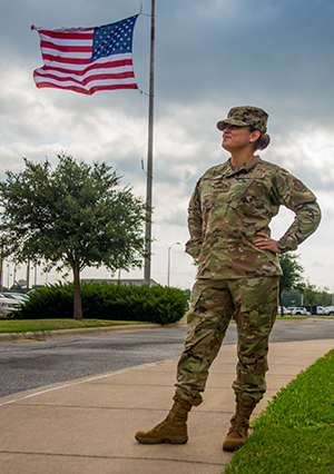 Texas Air National Guard Major Adrienne Saint, 136th Airlift Wing Logistics Readiness Squadron Officer, takes a moment to celebrate four years of being breast cancer-free September 27, 2020, at Naval Air Station Joint Reserve Base Fort Worth, Texas. After her diagnosis in 2016, Saint had five major surgeries over the span of 18 months. Understanding Citizen Airmen and their personal struggles boosts the resiliency of military and civilian Air Force members. (Texas Air National Guard photo by Airman 1st Class Laura Weaver)