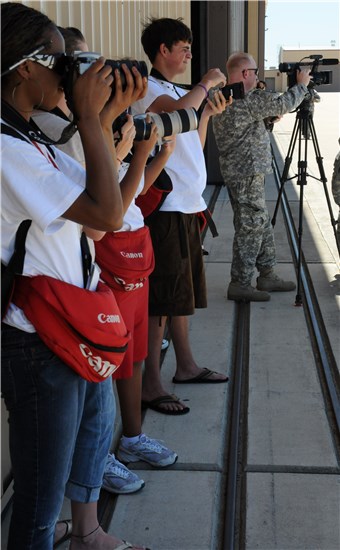 A group of Backpack Journalists take some photos Aug. 22 on an expedition to the Texas Army National Guard airfield during the 132nd National Guard Association of the United States General Conference in Austin, Texas.