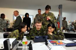 Master Sgt. Daniel Griego Capt. Jolana Fedorkova, Capt. Jan Sulc, Capt. Miroslava Stenclova and 1st Lt. Denisa Smitalova, of the Czech Republic Armed Forces, look at some materials during the annual Texas Military Forces Public Affairs Conference.