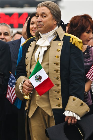A George Washington portrayer hold a small Mexican flag to represent the unity of not only the twin sister cities of Laredo and Nuevo Laredo, but The United States and Mexico themselves in All I Want for Christmas Is New Year's Day.