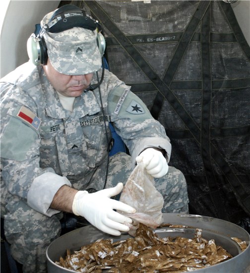 Private Paul Pettit, 3rd Battalion, 1st Regiment, Texas State Guard, unloads a bag of bait to be dropped over the South Texas Zapata area during the 2012 Texas Oral Rabies Vaccination Program. 