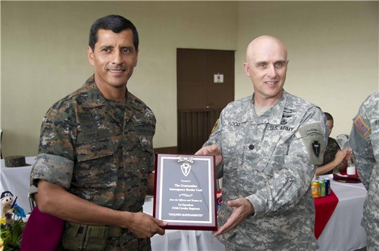 U.S. Army Lt. Col. Anthony Flood, commander 1st Squadron, 124th Cavalry Regiment, Texas Army National Guard, presents National Army of Guatemala Brig. Gen. Antonio Lopez, commander of the Interagency Task Force Tecun Uman, with a plaque for his unit's successful training. 