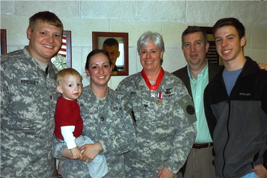 Col. Deanne E. "Dea" Lins, a member of the T xas Army National Guard, stands with her family at Camp Mabry, in Austin, Texas, Jan. 12, 2013. Lins received the Meritorious Service Medal and retired after more than 30 years of service to the state and nation