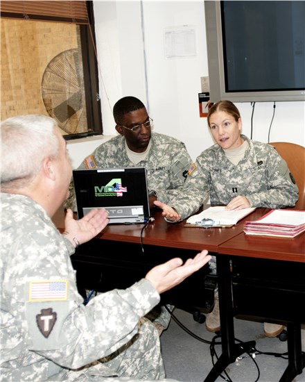 Texas Army National Guard Capt. Kimberly Spires, Medical Hold officer in charge, Texas Medical Command and Texas Army National Guard Cpl. Derrick Guy, state health systems specialist, conduct a mock medical evaluation board (MEB) for a wounded Texas Army National guardsman. 