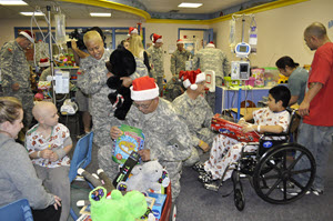Guardsmen from the19th Regiment, Texas State Guard (TXSG), provide toys to children during the holidays at Medical City Children's Hospital in Dallas, Dec. 13, 2014. The toy donation was a part of the TXSG’s Young Heroes of the Guard toy drive. Thanks to generous donations from Texas guardsmen and members of the community, over 3,500 toys were delivered to three different hospitals in Dallas during the holidays: Children’s Medical Center of Dallas, Medical City Children’s Hospital, and Our Children’s House of Baylor. (Texas State Guard photo by Capt. Esperanza Meza/Released)