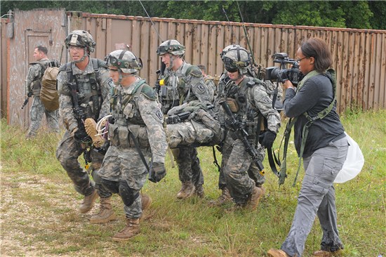 Sgt. Marlene Duncan, 100th Mobile Public Affairs Detachment, Texas Army National Guard, right, role plays as a civilian media reporter during Operation Saber Junction held at Hohenfels in Nuremburg, Germany, Sept. 10, 2014. 