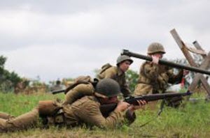 Courtesy Photo A Soldier with the 36th Infantry Division fights against enemy German Soldiers during a WWII reenactment at the Texas Military Forces Open House and Air Show at Camp Mabry April 18, 2015. Camp Mabry and its facilities are open to the public. Events like these help to form a better relationship and understanding between Texas Military Forces and the Austinites who live around the post.
