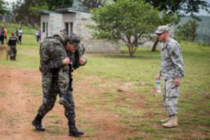 Maj. Randall Stillinger  First Lt. Raymond Bayane (right) observes two Honduran soldiers practice a 'fireman’s carry' during a training exercise in Tamara, Honduras. Bayane is with the San Antonio-based 1st Battalion, 141st Infantry Regiment, which is conducting the training to enhance the Honduran Army’s ability to counter transnational organized crime (CTOC). 36th Infantry Division Soldiers of the Texas Army National Guard are spending four months in Central America creating a knowledgeable and trained force that is able to detect, disrupt and detain illicit trafficking across the region. (U.S. Army photo by Maj. Randall Stillinger)