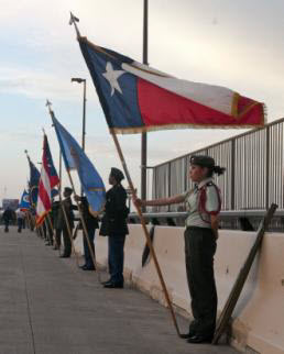 Sgt. Michael Vanpool Isela Flores, a senior at Martin High School in Laredo, Texas, holds the Texas state flag at parade rest during the International Bridge Ceremony in Laredo, Texas, Feb. 21. The ceremony commemorates the bonds between the United States and Mexico and features a series of abrazos, or embraces, between representatives of the two countries in the center of the bridge. (U.S. Army National Guard photo by Sgt. Michael Vanpool, 36th Infantry Division Public Affairs/Released)