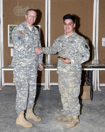 1st Lt. Alicia Lacy Spc. Jordan Norkett, C Troop, 1-124 Cavalry Regiment, 56th Infantry Brigade Combat Team, 36th Infantry Division, Texas Army National Guard, receives the second place novice award from Maj. John B. Conley following the Texas Military Forces' Governor's 20 Sniper competition Feb. 22, 2015, at Camp Swift near Bastrop, Texas. Only one team of two, a sniper and a spotter, can make up the Governor's 20.