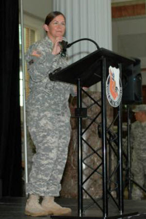 Sgt. Elizabeth Peña Warrant Officer Audrey M. Foushee speaks during the deployment ceremony for the Texas National Guard's 136th Expeditionary Signal Battalion, hosted by the Houston Astros, at Minute Maid Park in Houston, Texas, July 18, 2015. This marks the first time that the Texas National Guard has been supported by a Major League Association for a mobilization event. (Texas Army National Guard photo by Sgt. Elizabeth Pena/Released)
