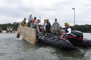  Capt. Maria Mengrone Texas Army National Guard soldiers on state active duty, conduct critical water rescue rehearsals with first responders from Texas Task Force 1 (TXTF-1), while on standby to respond to flooding in the North Texas region, May 16, 2015. Guardsmen provided light medium tactical vehicles to emplace TXTF-1 inflatable boats in flood waters to simulate potential flood victim rescues in controlled conditions. Guardsmen often work side by side with local and state partners to help Texans in need during disaster situations. (U.S. Army National Guard photo by Capt. Maria Mengrone)