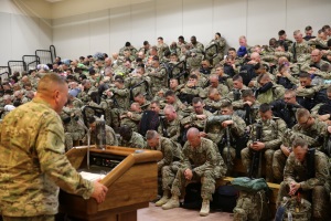 Photo By Adam Holguin | Soldiers assigned to the 389th Engineer Company and the 176th Engineer Brigade are led in prayer during the farewell brief at the Silas L. Copeland Airfield Control Group moments before boarding their flight to the Middle East July 29.