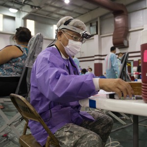 Lt. Col. John Hsu, a dentist in the 804th Medical Brigade, U.S. Army Reserves, Operations Chief for Dental Services, prepares to treat a patient at an Operation Lone Star site in Pharr, Texas, July 27, 2016. Service members from the Texas State Guard worked alongside Soldiers from the 804th Medical Brigade, U.S. Army Reserves, the Texas Department of Public Safety, the Department of State Health Services, Remote Area Medical volunteers, Cameron County Department of Health and Human Services (DHHS), City of Laredo Health Department, Hidalgo County DHHS and U.S. Public Health Services during Operation Lone Star (OLS), a week long real-time, large-scale emergency preparedness exercise in La Joya, Pharr, Brownsville, Rio Grande City and Laredo, Texas, July 25-29, 2016. OLS is an annual medical disaster preparedness training exercise, uniting federal, state and local health and human service providers, that addresses the medical needs of thousands of underserved Texas residents every year. (U.S. Army National Guard photo by Sgt. 1st Class Malcolm McClendon)