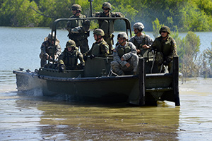 Service members from the Texas National Guard's 386th Engineer Battalion, the 551st Multi Role Bridge Company, U.S. Army's 20th Engineer Battalion, and the Czech Republic 15th Engineer Regiment conduct a wet gap crossing during a operation rehearsal June 20, 2016, at Fort Hood, Texas, as part of a Multinational Lumberjack River Exercise. Through the States’ Partnership Program, the Texas Army National Guard currently works alongside the Czech Republic and Chile to conduct military operations in support of defense security goals. (U.S. Army National Guard photo by Sgt. Elizabeth Pena/Released)