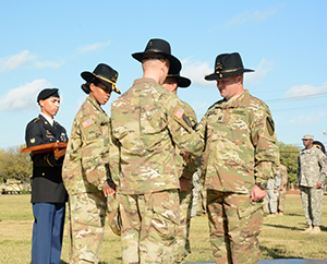 U.S. Army Capt. Lucas Hamilton, commander 249th Transportation Company, receives his cavalry Stetson from Lt. Col. Daryl Morse, commander Special Troops Battalion, 1st Cavalry Division Sustainment Brigade during a patch-over ceremony held on Fort Hood, Texas. (U.S. Army photo by Sgt. James Strunk Released) Photo cropped to highlight subjects, 161016-Z-IX228-563PS