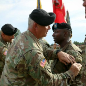 (Photo by Staff Sgt. Nathan Akridge) Command Sgt. Maj. Ronald Bly, senior enlisted adviser for 3rd Brigade Combat Team, 10th Mountain Division (LI), places the 36th Infantry Division patch on a battalion command sergeant major during a ceremony Friday at Fort Polk, La. The 3rd Brigade Combat Team is the first active-duty brigade to wear a National Guard unit's patch and is currently the only active Army unit wearing a National Guard patch.