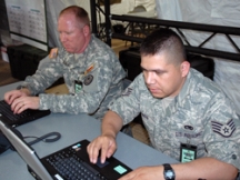 Sgt. Marc Jones (left) of the Texas Army National Guard’s Standing Joint Interagency Task Force (SJIATF) and Staff Sgt. Gonzalo Roman of Texas Air National Guard 149th Fighter Wing at San Antonio Emergency Operation Center as Hurricane Dolly moves westward towards south Texas Aug. 23. The Category 2 hurricane that is the first of the 2008 Atlantic Hurricane season severely damaged the coastal cities Brownsville and South Padre Island with strong winds and heavy flooding. (Texas Military Forces by First Sgt. Lek Mateo, 100th Mobile Public Affairs Detachment)