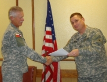 Maj. Roger Vertrees of the TMB receiving Meritorious Service Ribbon from Capt. Alec Ross Photo by 2LT Tom Goff