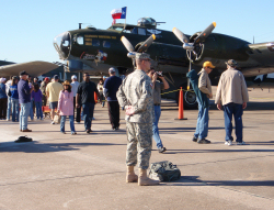 A 8th Regiment, Texas State Guard, Soldier provides flight line crowd control in front of Commemorative Air Force Boeing B-17G Flying Fortress “TEXAS RAIDERS”.Photo by 1LT Joseph Conte, 8th Regiment Public Affairs, Texas State Guard