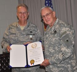 Photo of Major General Raymond Peters presenting the Commander's Award for Public Service to retiring Brigadier General Robert Cheeseman.