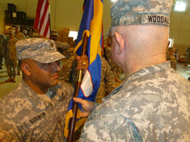 Photo of MAJ Alfred Sustaita, Jr., recieving the colors from COL Frank Woodall