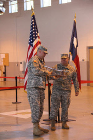 MAJ Britton presents LTC Krueger with the Cavalry Saber from the 2nd Bn. Photographed by SPC Hays, 2nd Bn., 8th Regt. 16 AUG 2014