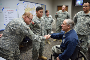 Texas Governor Greg Abbott shakes hands with Staff Sgt. William Willey, and thanks Capt. Michael Garcia, Staff Sgt. Brenda Newton, Spc. Zach Willams, and Spc. Desmon Dunn from the 39th Composite Regiment for their service during flood emergency in Wichita Falls, Texas, May 25, 2015.  (Texas State Guard photo by 39th Regiment/Released)