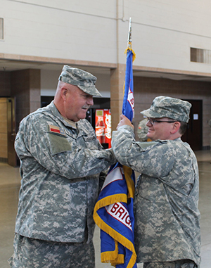 Lt. Col. Jeremy Franklin, incoming commander of the 39th Composite Regiment, Texas State Guard. Brig. Gen. Howard N. Palmer, Jr., Commander, Army Component Command, Texas State Guard, hands the regimental guidon to Franklin in a change of command ceremony in Lubbock, Texas, April 23, 2016.  Franklin had previously served as the Executive Officer and Chief Medical Officer of the 39th. (Texas State Guard photo by Chief Warrant Officer 2 Janet Schmelzer).