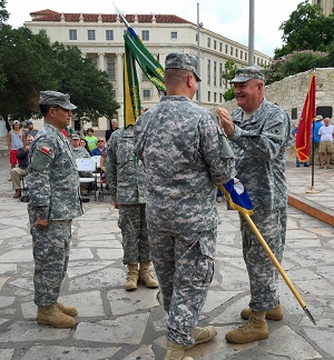 Col. Kris Krueger became the new commander of the 1st Regiment, Texas State Guard, in a change of command ceremony in front of the Alamo, in San Antonio, Texas, July 16, 2016.  Brig. Gen. Howard N. Palmer, Jr., Commander, Army Component Commander, Texas State Guard, presented the guidon of the 1st Regiment to Krueger.  The guidon or colors of the unit symbolizes the transfer of authority and responsibility to a new commander.   (Photo by Staff Sgt. Juan Trevino, Texas State Guard)