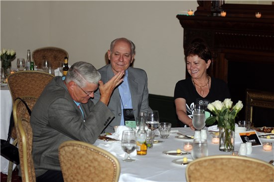 Attendees of the Texas Adjutant General Dinner at the Driskill Hotel during the National Guard Association of the United States Conference pass the time through laughter with new friends.