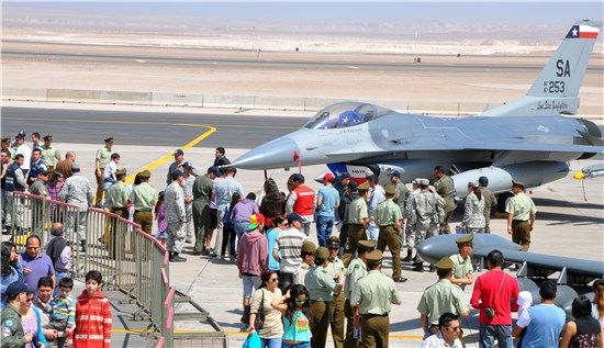 Onlookers from various agencies and branches of the Chilean government, along with their families, visit with Airmen from the Texas Air National Guard.