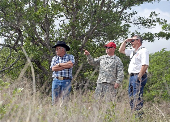 Lt. Col. Jamey Creek, Training Center Garrison Command manager and officer in charge- Camp Bowie, Texas Army National Guard, center, Brownwood resident and Camp Bowie neighbor Phil Richey, left, and Del Albright, Ffire chief and emergency management coordinator, City of Brownwood, Texas, right, overlook a hill on the north side of Camp Bowie after discussing business, May 16, 2013
