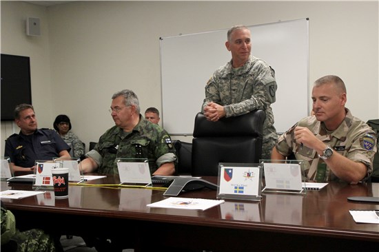 In this image released by Joint Task Force 136 (Maneuver Enhancement Brigade), Brigade Commander Col. Lee Schnell briefs delegates of the Swedish Armed Forces International Centre during their visit to the Round Rock Armed Forces Reserve Center Oct. 28, 2014. The group of service members from Sweden, Finland, and Norway toured various military and civil agency sites throughout central Texas to learn more about the National Guard approach to disaster response.