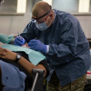 A Soldier from the 804th Medical Brigade, U.S. Army Reserves provides dental services to a patient in need during an annual medical disaster preparedness exercise in Pharr, Texas, July 27, 2016. Service members from the Texas State Guard worked alongside Soldiers from the 804th Medical Brigade, U.S. Army Reserves, the Texas Department of Public Safety, the Department of State Health Services, Remote Area Medical volunteers, Cameron County Department of Human Health Services (DHHS), City of Laredo Health Department, Hidalgo County DHHS and U.S. Public Health Services during Operation Lone Star (OLS), a week long real-time, large-scale emergency preparedness exercise in La Joya, Pharr, Brownsville, Rio Grande City and Laredo, Texas, July 25-29, 2016. OLS is an annual medical disaster preparedness training exercise, uniting federal, state and local health and human service providers, that addresses the medical needs of thousands of underserved Texas residents every year. (U.S. Army National Guard photo by Sgt. 1st Class Malcolm McClendon)
