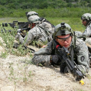 Soldiers with Company A, 2nd Battalion, 42nd Infantry Regiment, 56th Infantry Brigade Combat Team, look out from their attack positions behind a hill during a dismounted platoon attack lane at Fort Hood, Aug. 14. The brigade’s annual training, the Exportable Combat Training Capability program, allowed platoons to complete lanes and then to recap their performance during an instrumented after action review. (U.S. Army National Guard photo by Sgt. Michael Vanpool)