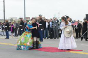 Staff Sgt. Melisa Washington Dignitaries from Laredo, Texas and Nuevo Laredo, Tamaulipas gathered on the Lincoln-Juarez International Bridge for the International Bridge Ceremony Feb. 20, 2016. The ceremony celebrates the bond between the United States and Mexico. The staple of the ceremony, the "abrazo" or embrace, is led by two children representing Mexico and two children representing the United States, affectionately know as the "abrazo children". Dignitaries including religious, political, and military officials follow suit by embracing and exchanging flags. (U.S. Army National Guard photo by Staff Sgt. Melisa Washington, 100th Mobile Public Affairs Detachment/Released)