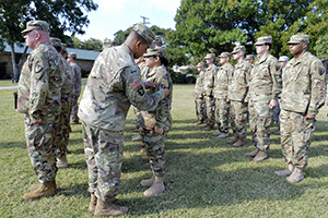 Col. Mark Quander, commander of the 36th Engineer Brigade, based in Fort Hood, Texas, removes removed their unit patch and replaces with 36th patch during a patch-over ceremony at Cherry Park in Weatherford, Texas, Oct. 15, 2016. Texas Army National Guard’s 840th Mobility Augmentation Company, based in Grand Praire joined efforts with the 36th Engineer Brigade, out of Fort Hood. The partnering of forces is the result of the Associated Unit Pilot Program, which is designed to increase the readiness and responsiveness of the Army as a total force. (U.S. Army National Guard photo by: Sgt. Elizabeth Pena)