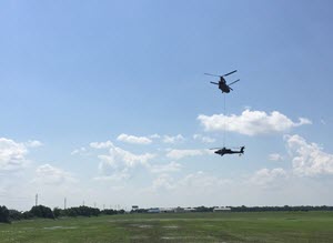 Texas Guardsmen conduct recovery operations of an AH-64D Apache helicopter using a CH-47 Chinook helicopter, September 1, 2016, following a precautionary landing in a rice paddy in Wallisville, Texas, near Houston, due to mechanical issues. Maintenance soldiers from the 1st Battalion, 149th Aviation Regiment (Attack Reconnaissance) waded through six-inch deep mud and worked in a heat index of more than 100 degrees, to ensure a safe and successful sling load recovery mission. (U.S. Army National Guard photo by Capt. Martha Nigrelle)