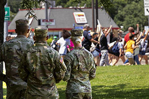 Photo By Staff Sgt. Mark Scovell | (BAYTOWN, Texas) -- Texas Army National Guard Soldiers assigned to 712th Military Police Company out of Houston, look on a peaceful group of protestors as they pass by on their way to a rally at Lee College in Baytown, Texas, on June 5, 2020. On May 30, 2020, Governor Greg Abbott activated elements of the Texas National Guard to augment law enforcement throughout the state in response to civil unrest. The Texas National Guard will be used to support local law enforcement and protect critical infrastructure necessary to the well-being of local communities. (U.S. Army photo by Staff Sgt. Mark Scovell) 
