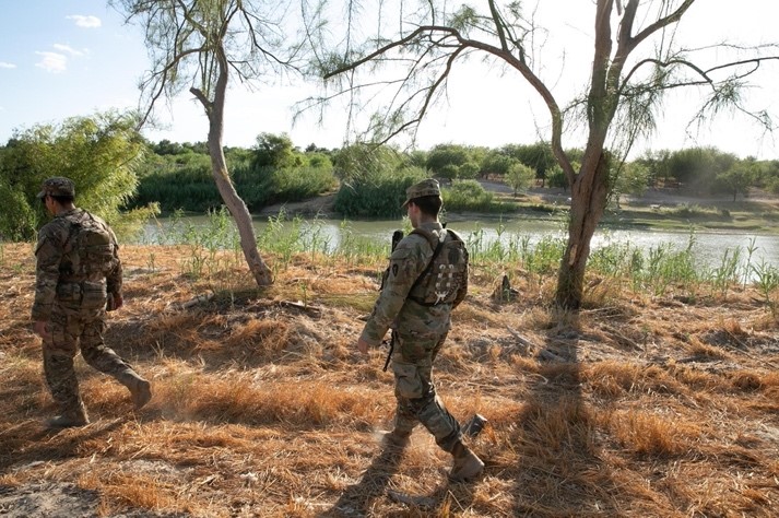 two soldiers walk near Rio Grande River 