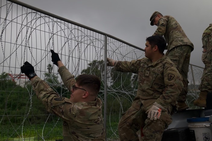 Soldier working on fence