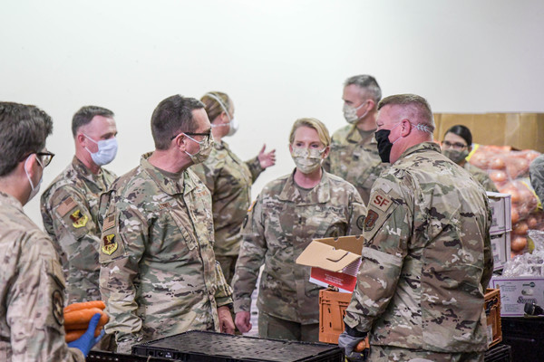 Gen. Joseph L. Lengyel, chief of the National Guard Bureau, along with Maj. Gen. Tracy R. Norris, the adjutant general of Texas, visit Texas National Guard service members serving at the Tarrant Area Food Bank in Fort Worth, Texas, April 29, 2020.