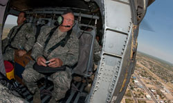 Col. Charles Bauer, M.D., (right) rides in a Black Hawk helicopter to the different sites of Operation Lone Star, a joint military and civilian training exercise and community service project.