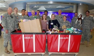 Group Photo with two large containers full of toys